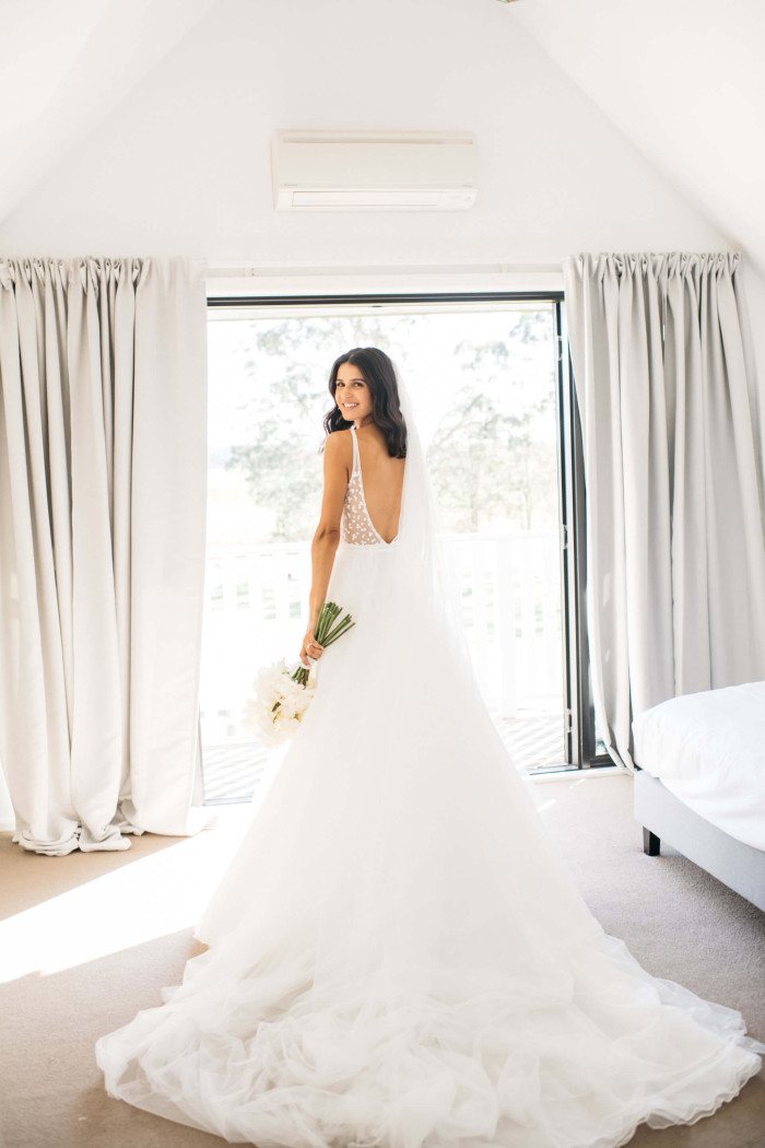 A bride at the suite window