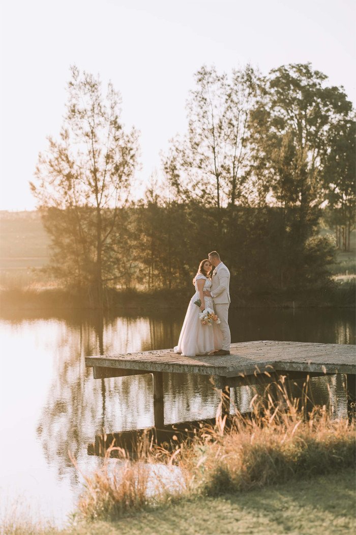 A couple on the dam jetty at sunset